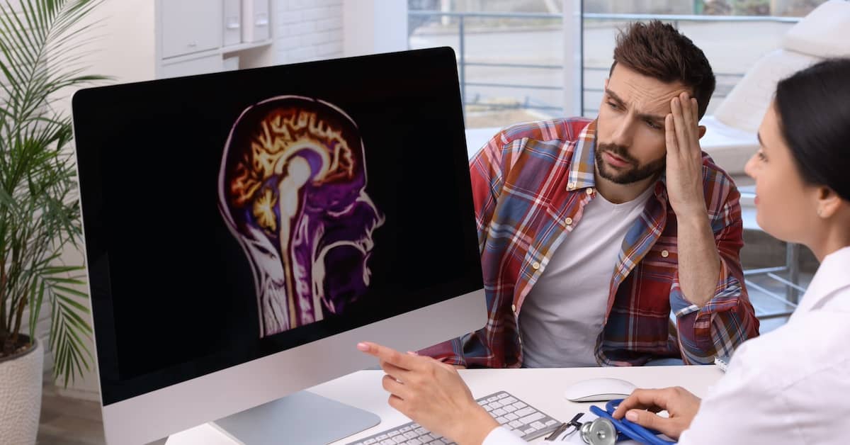 Neurologist reviewing brain injury scans with patient | Henry Carus + Associates