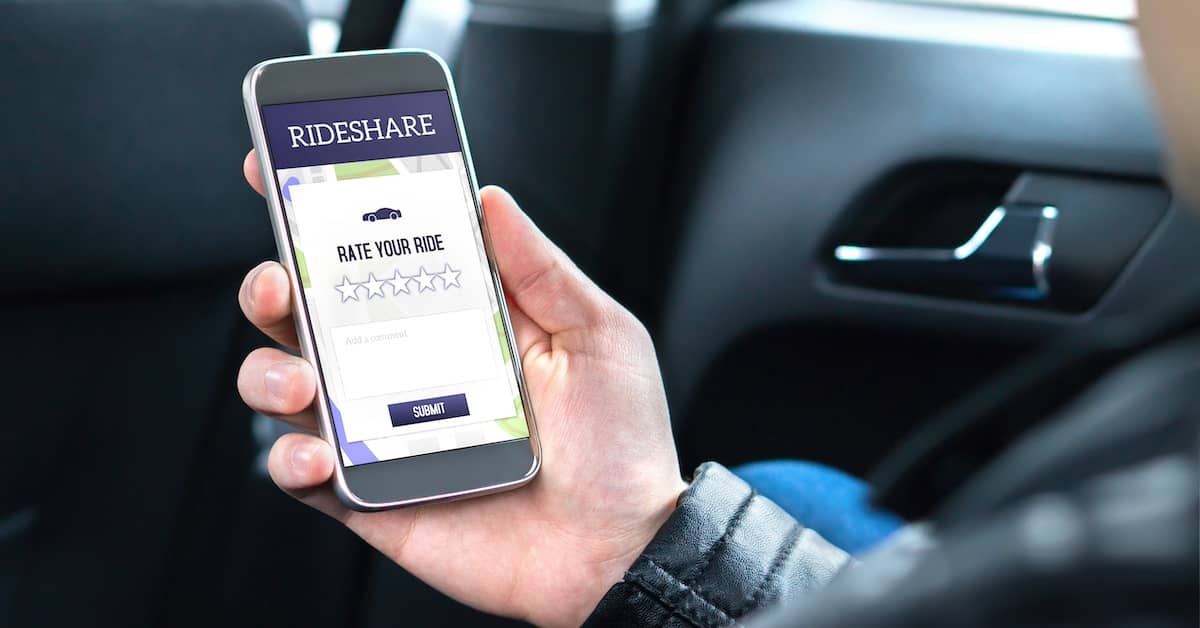 Rideshare driver checking the app on a mobile phone | Henry Carus + Associates