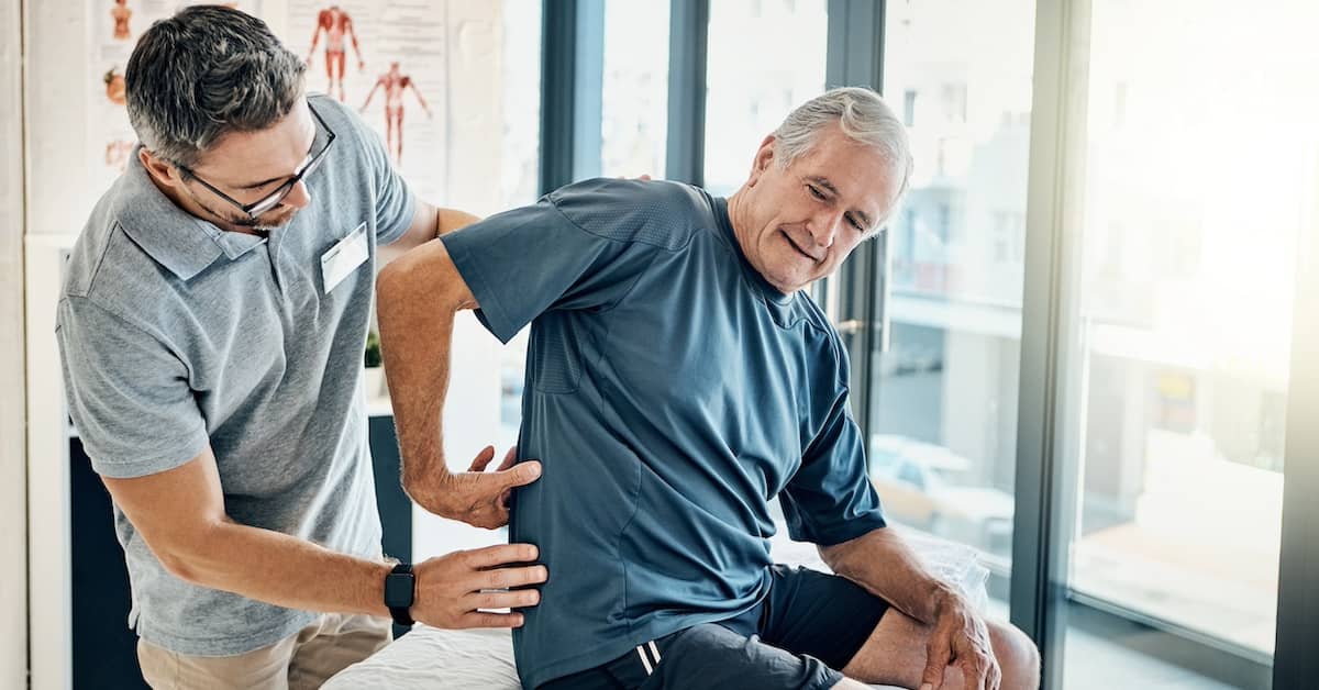 Man with back pain after injury | Henry Carus + Associates